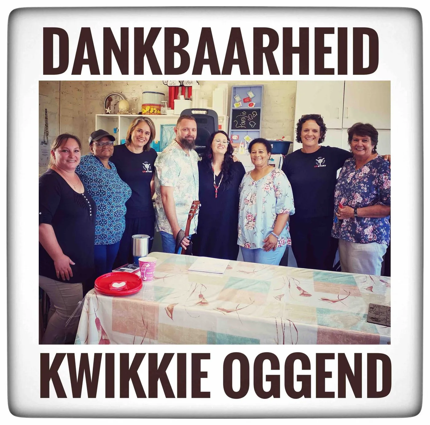 A group of women posing around a table with a cake, framed with the words Dankbaarheid and Kwikkie oggend.